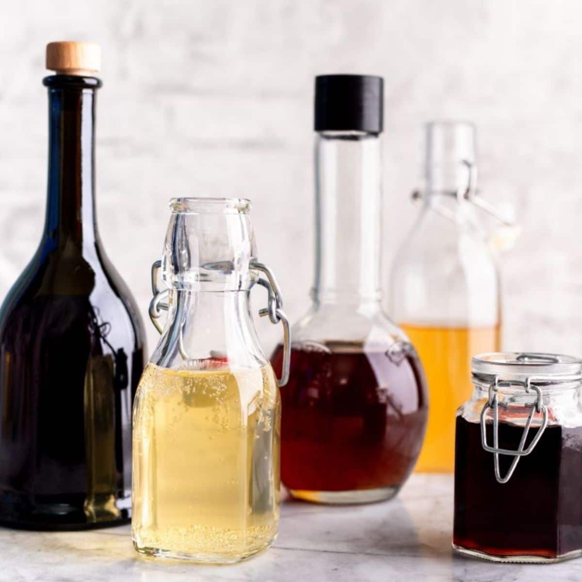 Different varieties of vinegar in glass bottles and jar