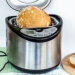 Silver bread maker with loaf of bread