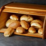Wooden bread box with loafs of bread inside