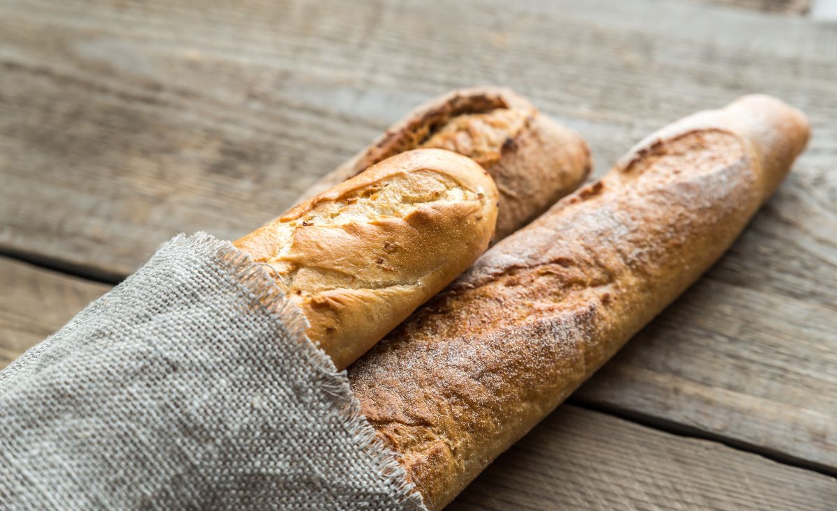 Baguettes in cloth bag on wooden table