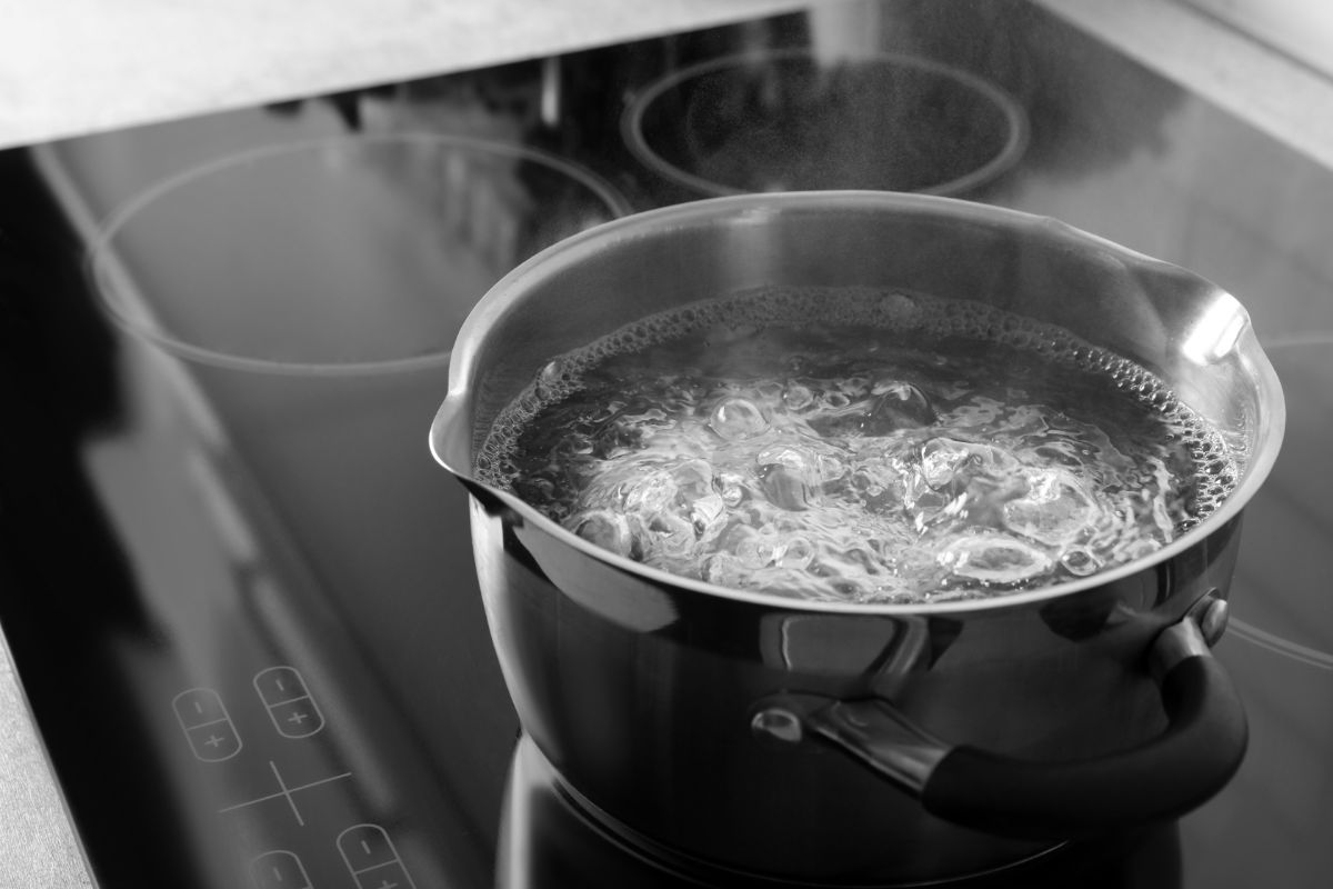 Boiling water in black pot