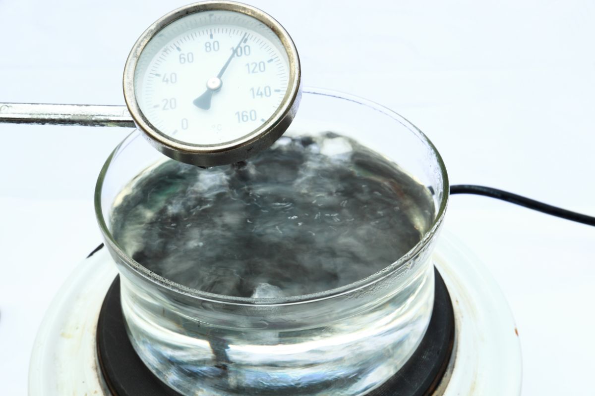 Boiling water in pot with thermometer