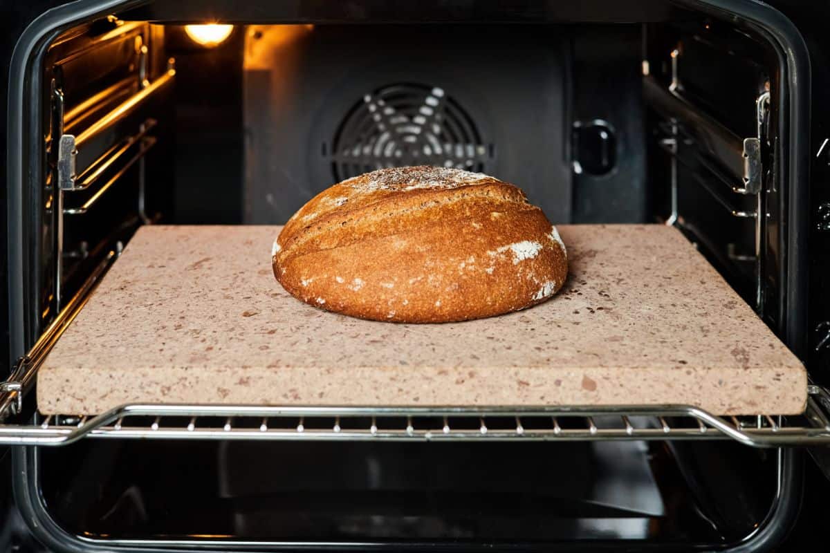 Loaf of bread on baking stone in oven