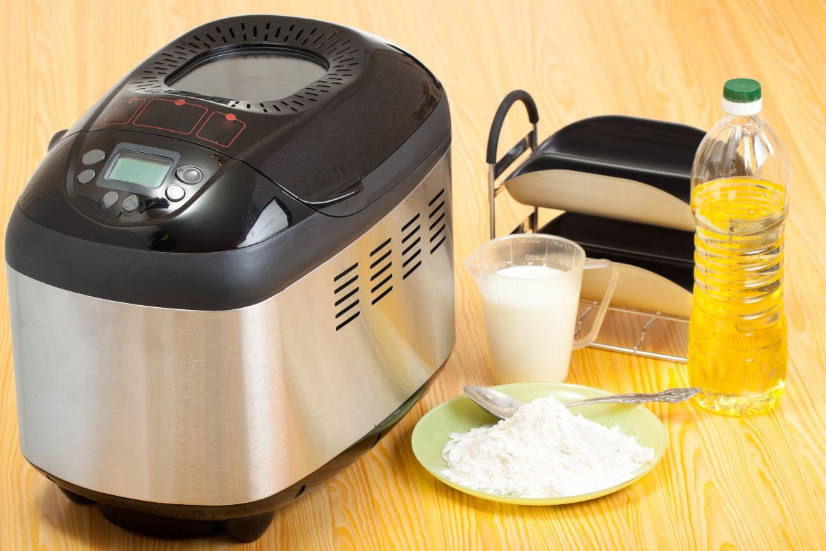 Breadmaker on table with ingredients around
