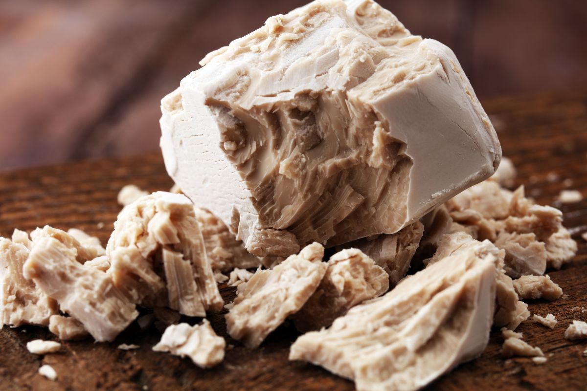 Crumbled block yeast on table