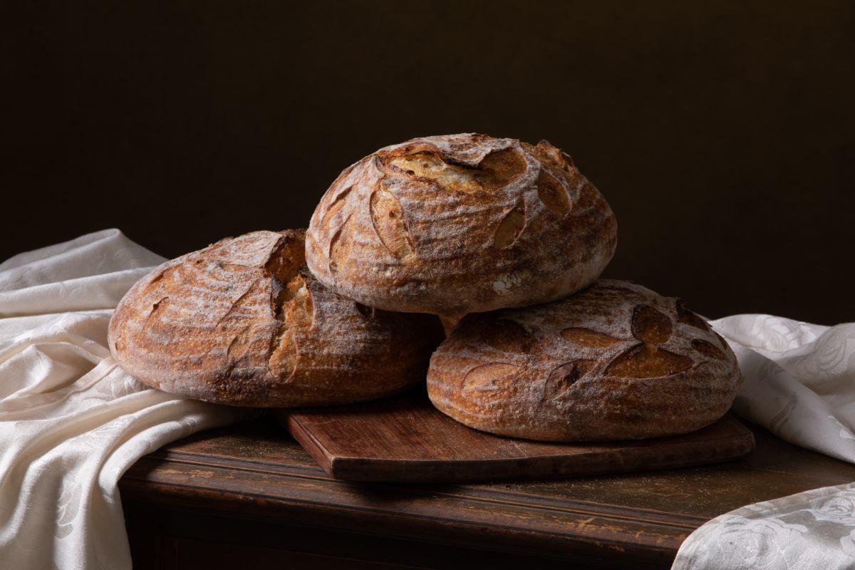 Fresh sourdough loaves of bread on wooden board