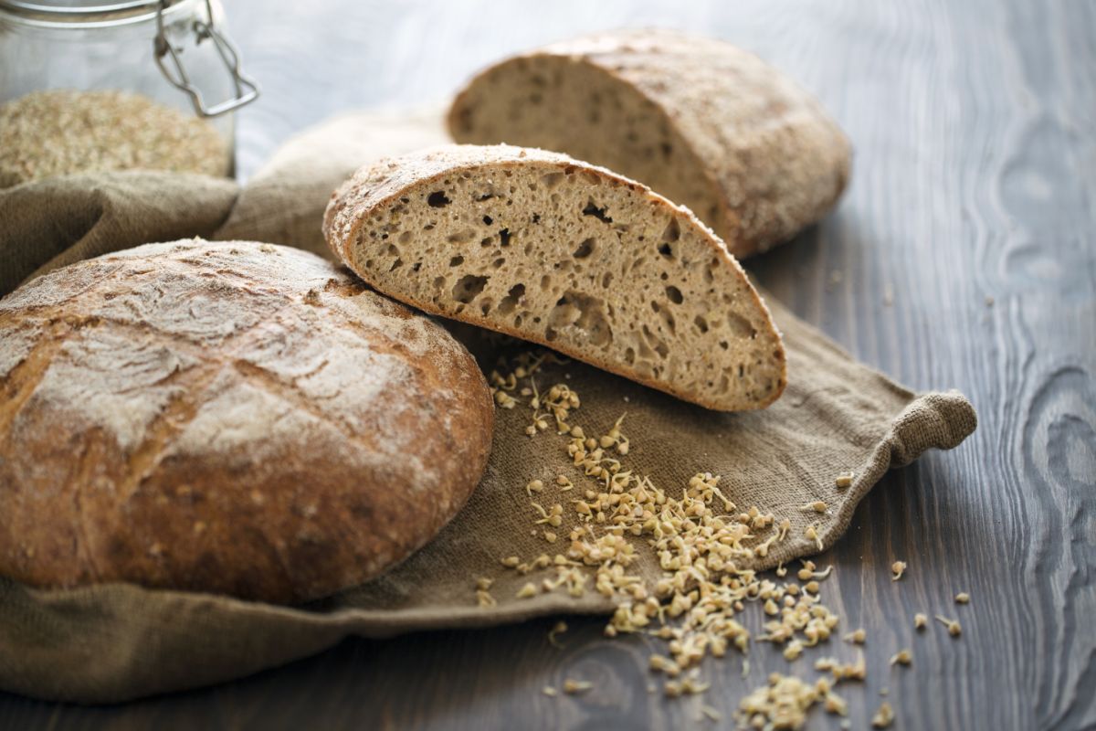 Laoves of bread on cloth on black wooden table