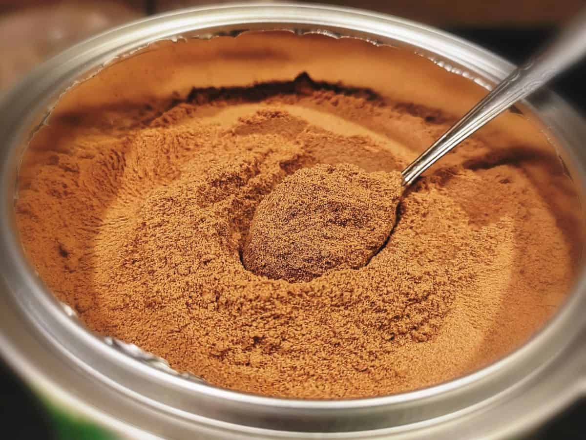 Malt powder in silver jar with spoon