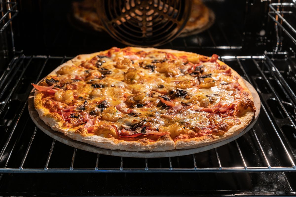 Pizza in oven on baking grid