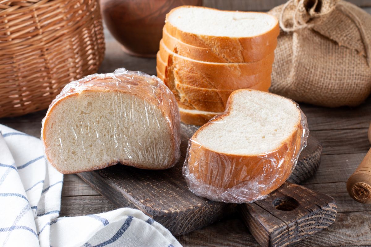 Sliced bread in piles on wooden pad