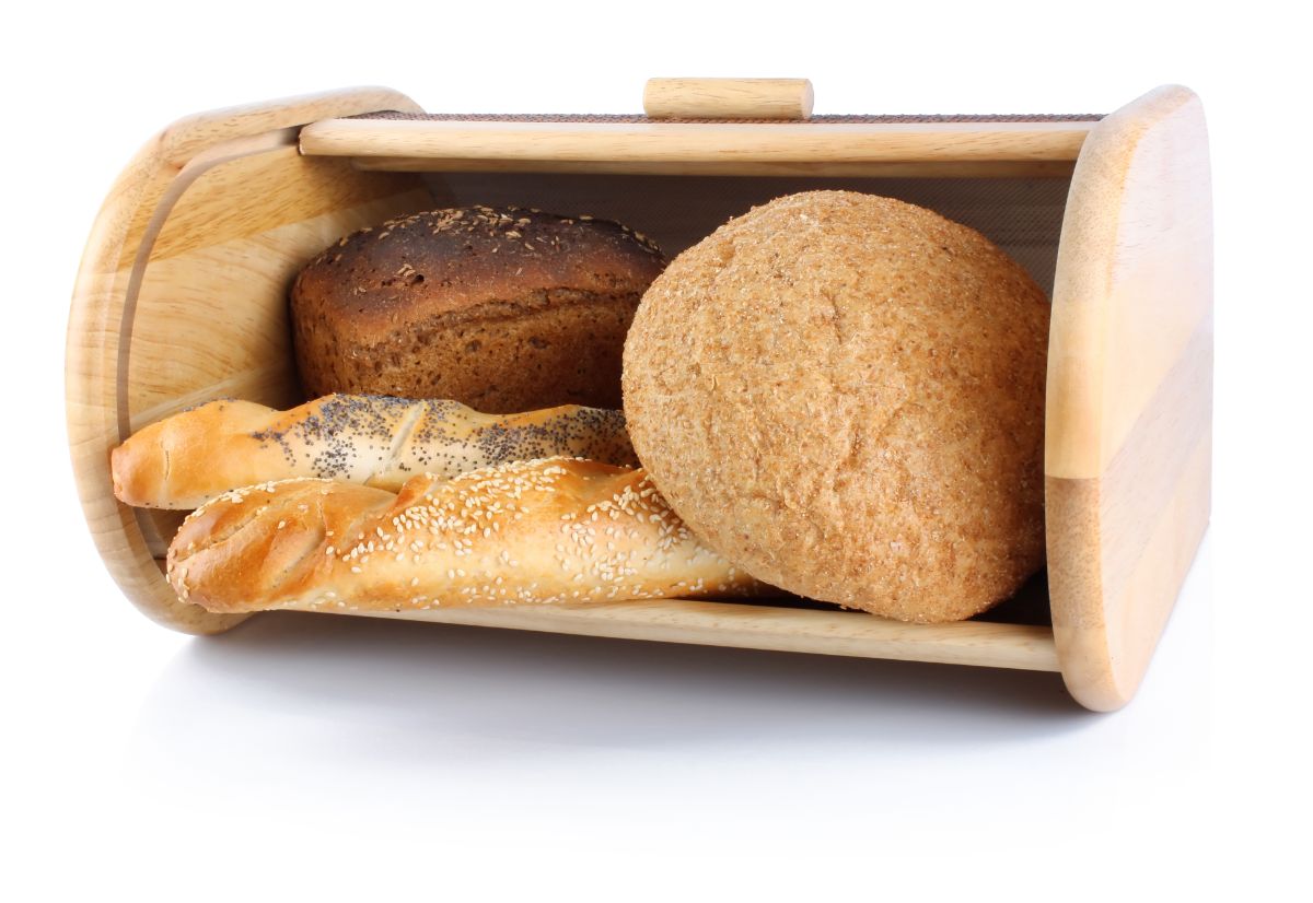 Wooden bread box full of loaves of bread