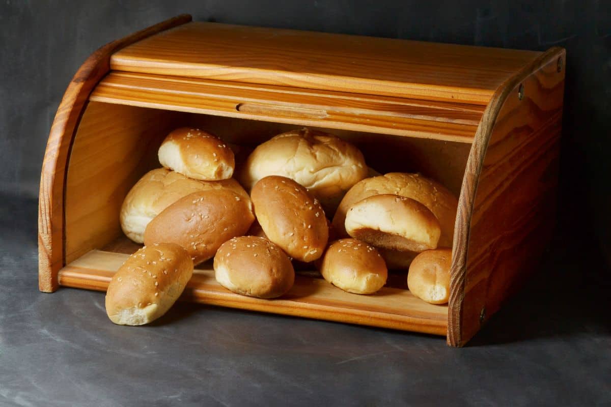 Wooden bread box with loafs of bread inside
