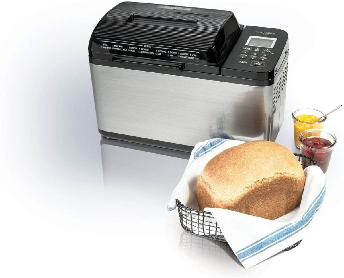 Zojirushi bread-maker with loaf of bread and ingredients around